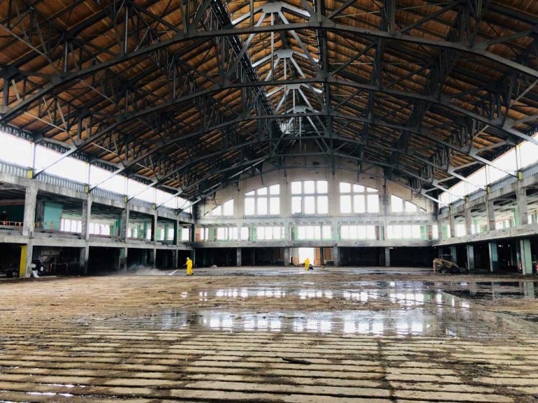 Workers cleaning warehouse